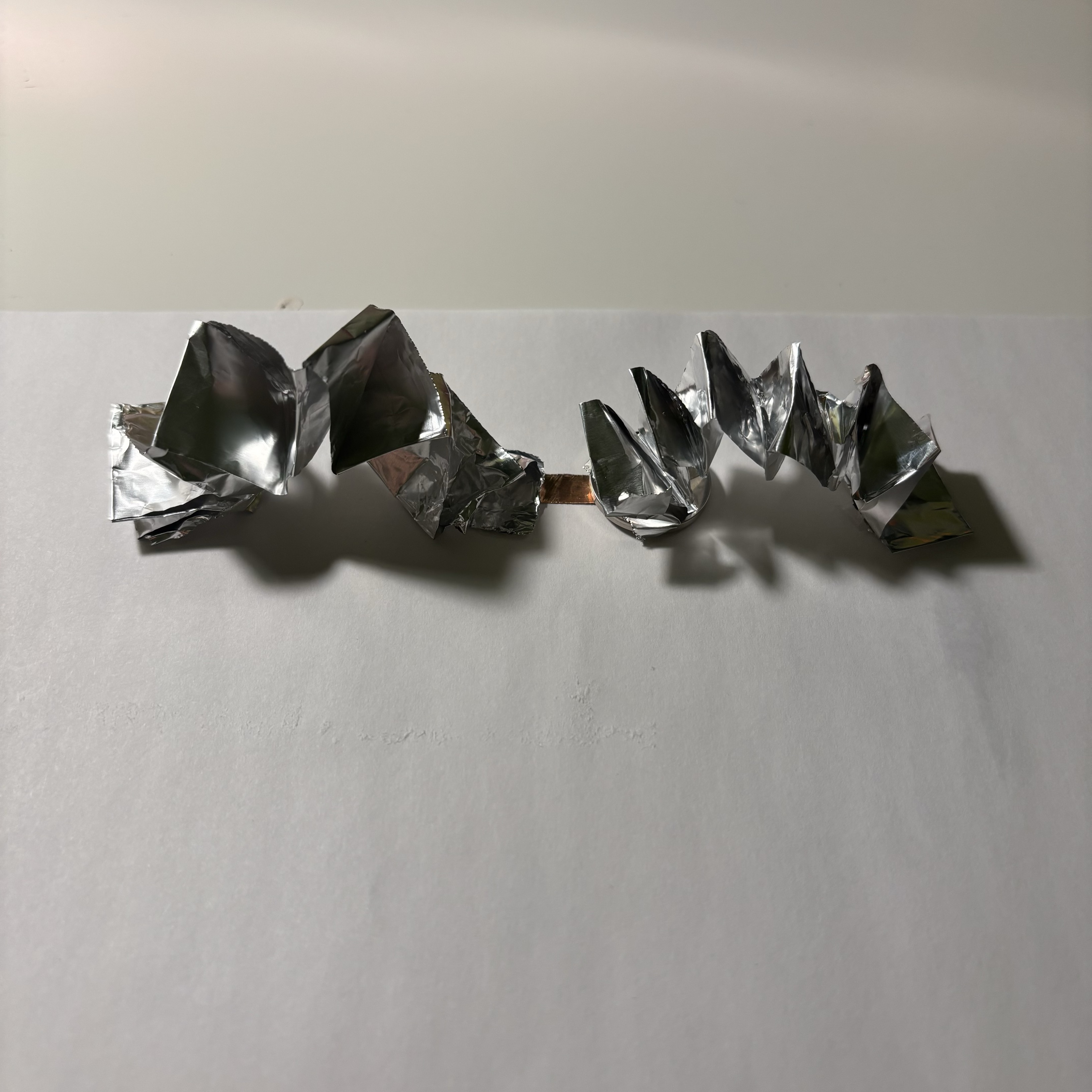 I stretched and glued aluminum foil springs to paper, I wanted them to be three-dimensional wires to add a 3D effect to my future designs. To ensure good energization, I used copper tape to connect the two springs.