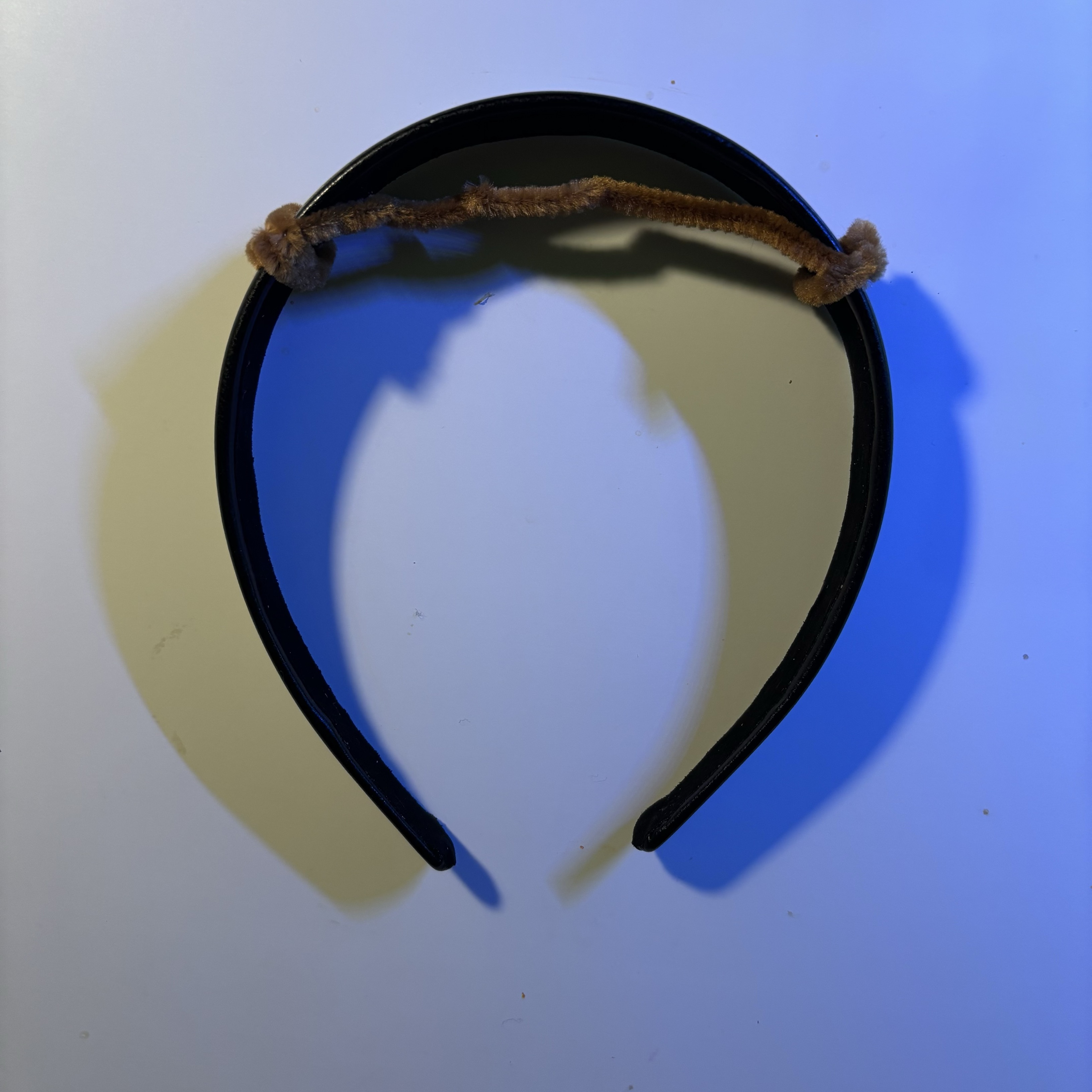 In one experiment, I adjusted the position of the fixed steel wire by moving it upward. This change prevented the steel wire from being overly taut, allowing it to be pressed onto the circuit. I still need to further test whether the circuit can be successfully connected and whether the elastic conductor will immediately detach from the circuit after removing the headband, ensuring the circuit's reset for the next use.