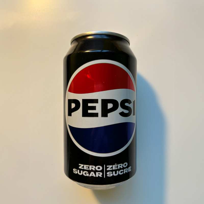 A front view of the can, which can be seen as a cylinder. The top and bottom are slightly deformed.