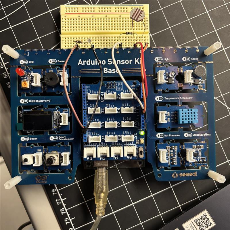 
Our initial idea was to use a sensor kit because it includes many different sensors, which we thought would give us a lot of creative possibilities. However, the biggest problem with the sensor kit is that there are very few tutorials available for it. As a result, we had to adapt Arduino Uno tutorials to the sensor kit by finding the corresponding pin locations on the board. The image shows our attempt to follow an Arduino Uno tutorial and recreate the same circuit on the sensor kit. But the circuit did not work, and the light sensor could not control the LED.
As a side note, we connected the LED not because it is part of our final design, but because it served as a clear indicator to help us see whether the circuit was actually working.
