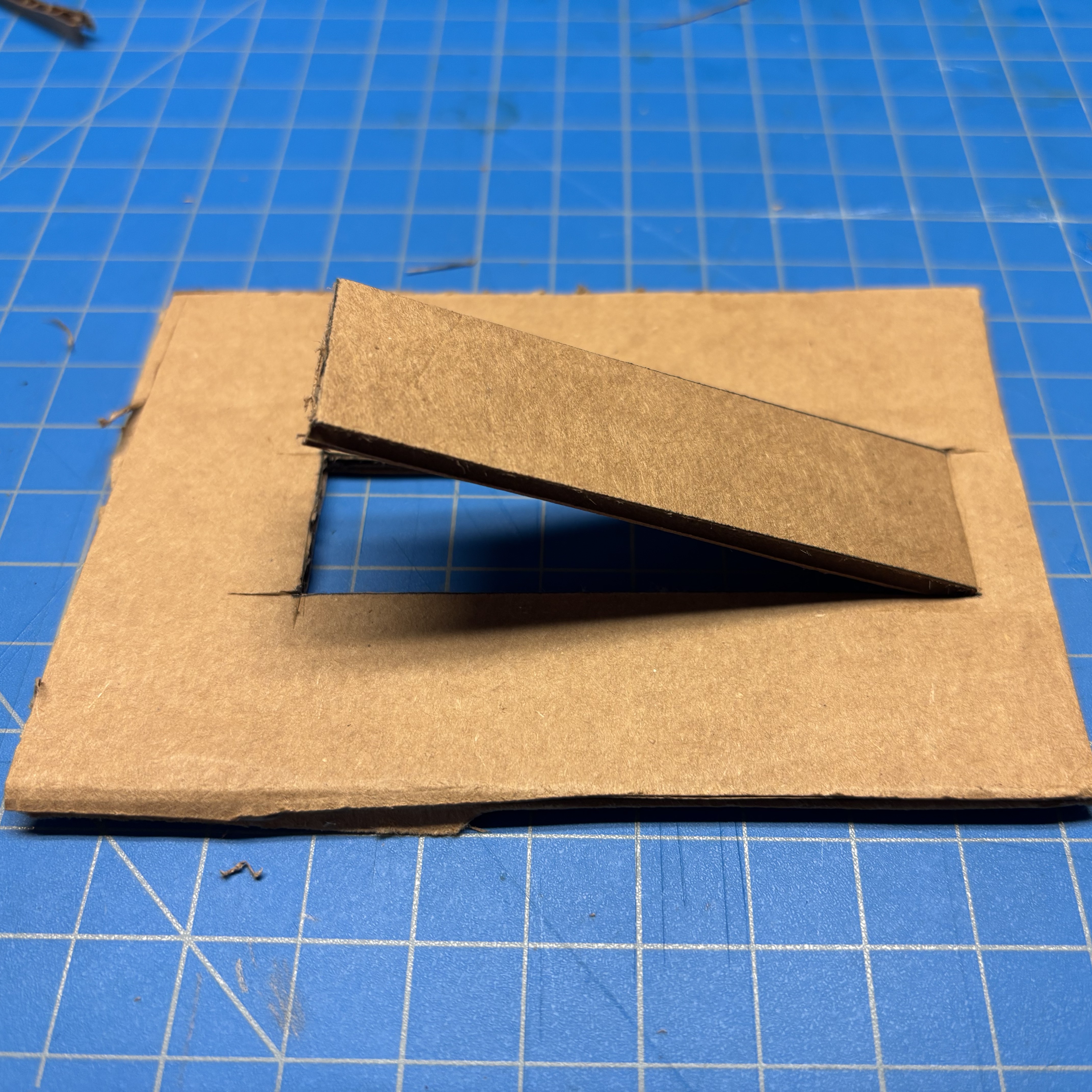 We cut out the base and support pieces, then created a rectangular slot on the base for inserting the adjustable support structure.