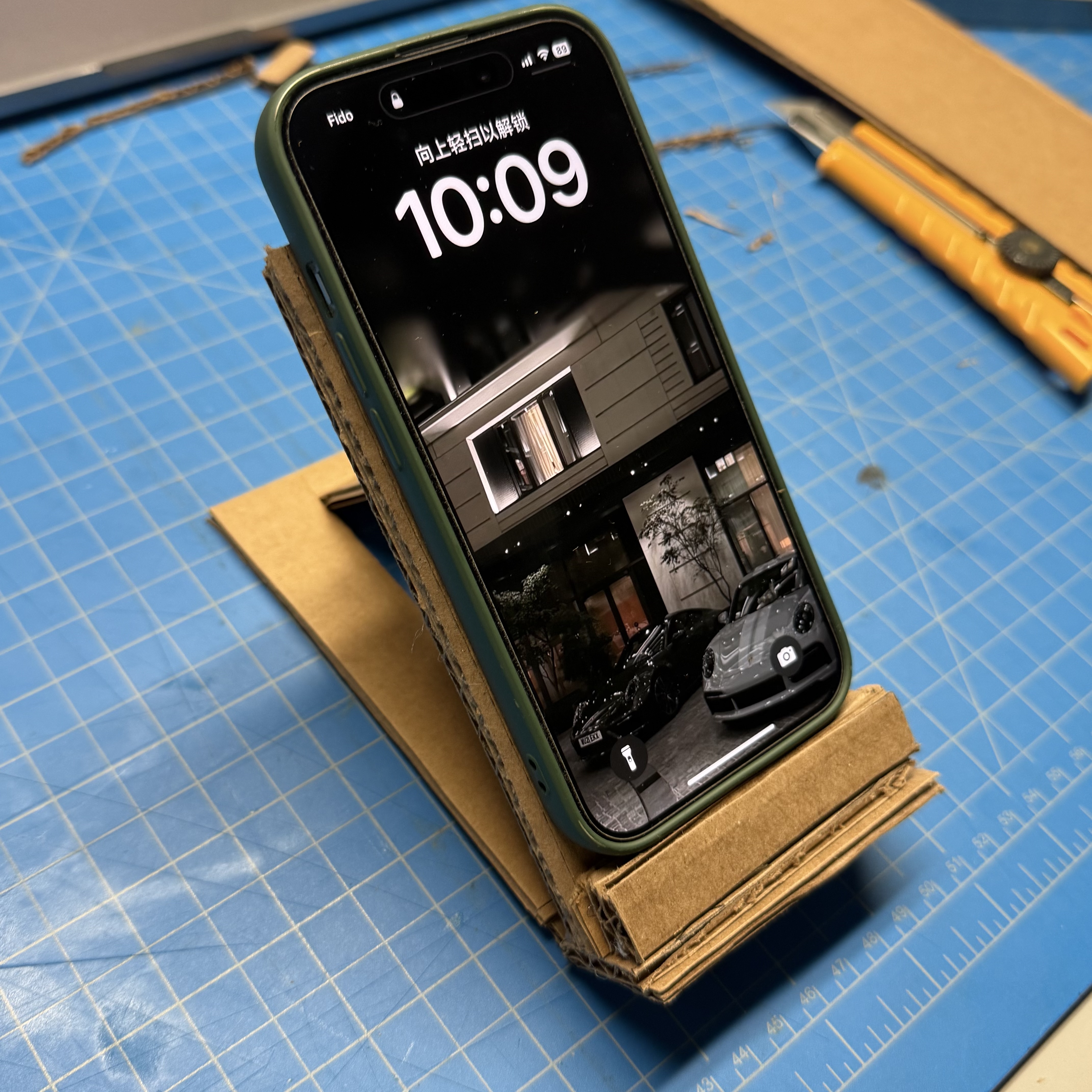 We focused on making the adjustable part first, but after finishing it, we realized the phone couldn’t stay on the board. To solve this, we glued two small cardboard strips together and attached them under the board to support the phone. We then inserted the support panel into the slot, forming a tilted angle to hold the phone securely.